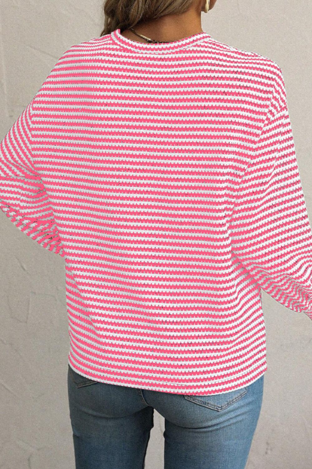 Pink and white striped textured blouse with balloon sleeves.