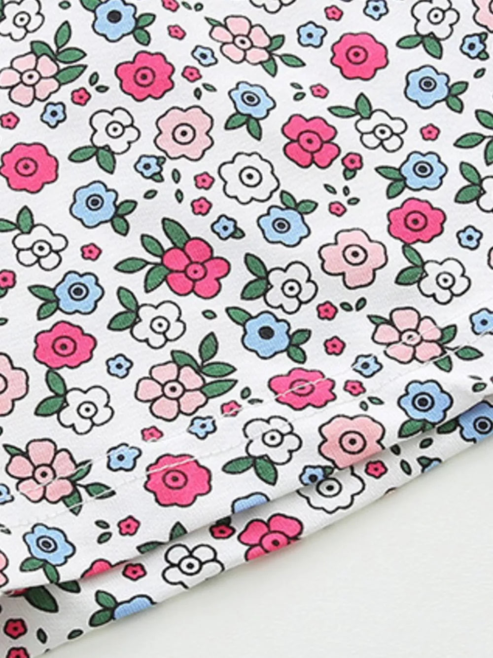 Girls' cotton bikini underwear with a white floral print in pink and blue.