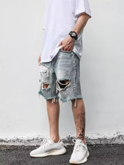 Men's distressed denim shorts in light blue with ripped details and frayed hem.