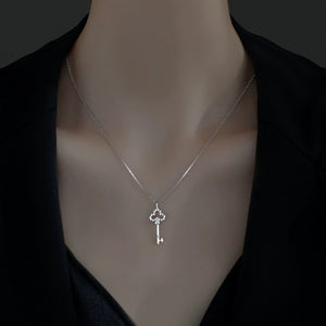 Delicate silver key pendant necklace with cubic zirconia accents.
