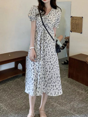 White botanical print midi dress with puff sleeves and tie waist