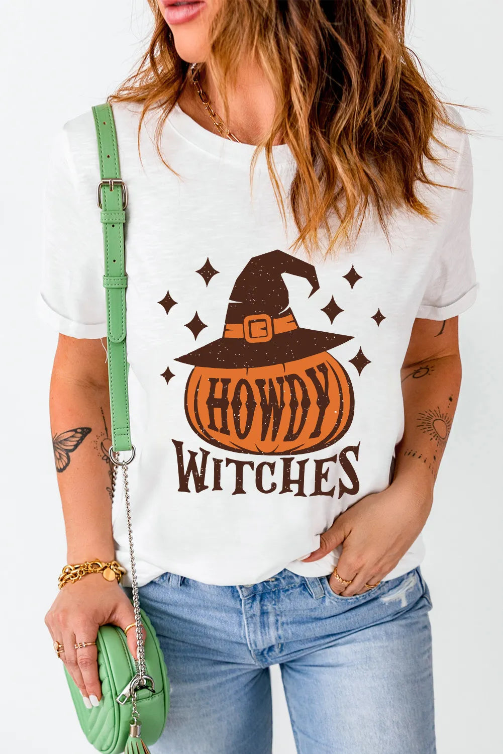 White cotton t-shirt with a witch hat pumpkin graphic and "Howdy Witches" text.