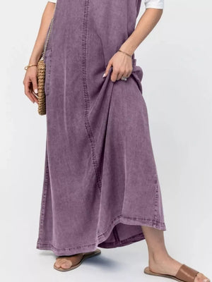 Washed denim maxi dress in gray purple with front seam detail and side pocket.