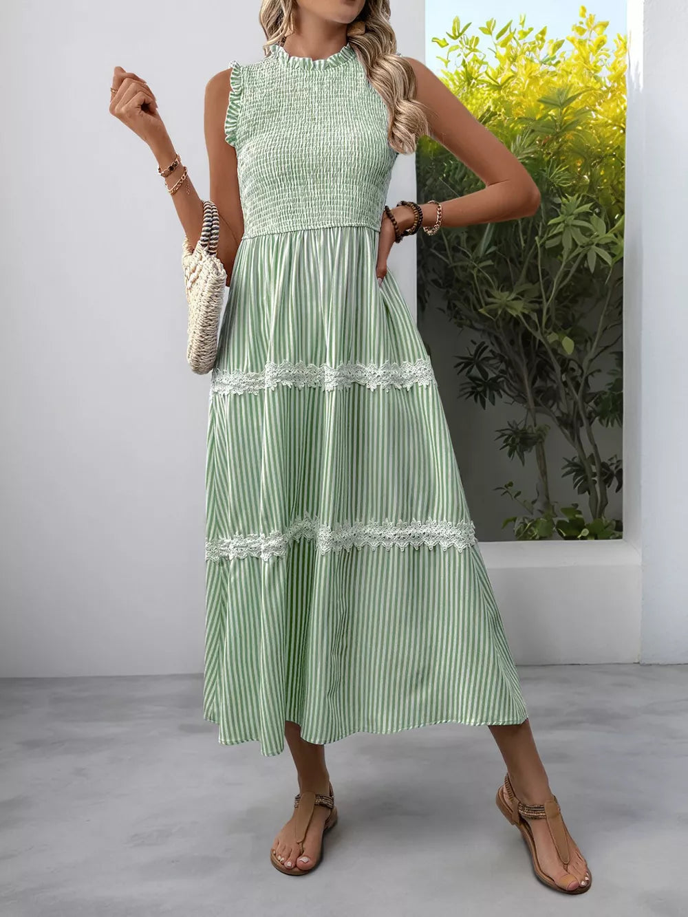Green striped midi dress with smocked bodice and lace trim.