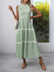 Green striped midi dress with smocked bodice and lace trim.