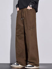 Brown loose-fit men's sweatpants with drawstring and pockets.