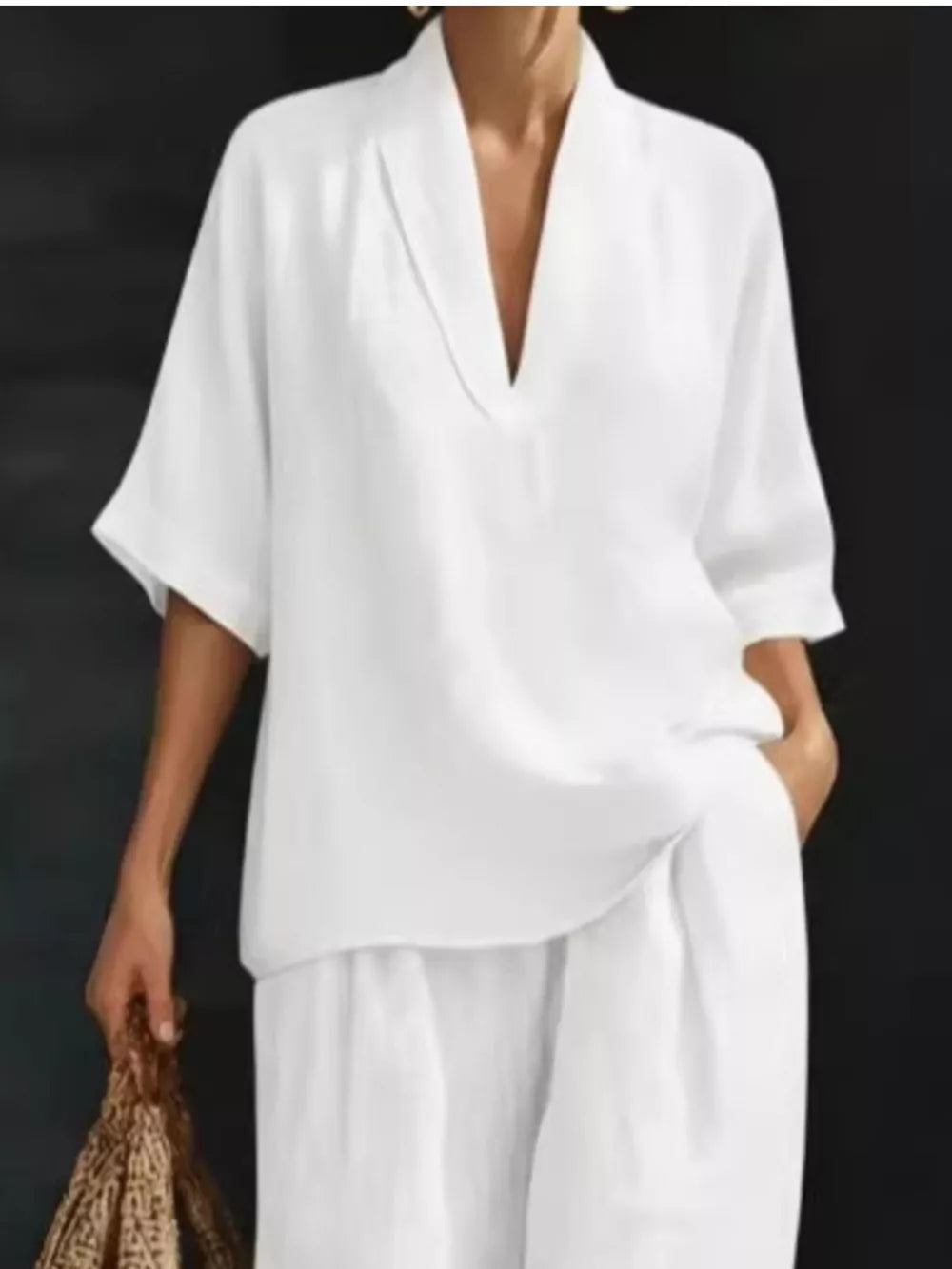 White half-sleeve top with V-neck and wide-leg pants set.