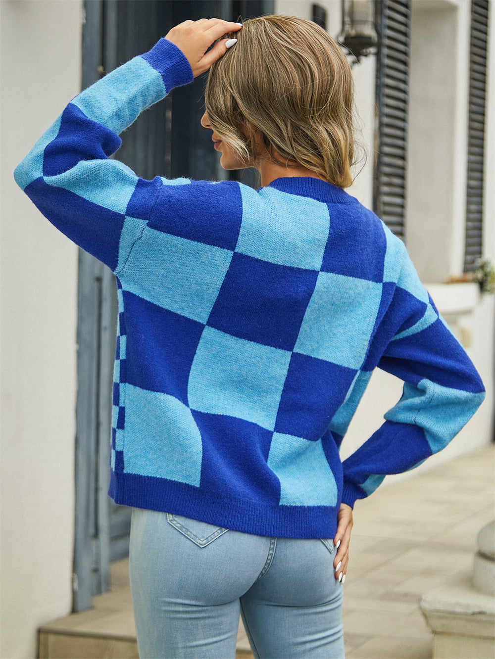 Checkerboard block knit cardigan in dark blue and light blue with crew neck and long sleeves.
