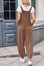 Brown corduroy overalls with barrel legs and a back pocket, styled with a white t-shirt.