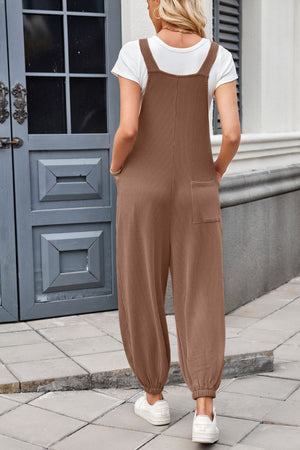 Brown corduroy overalls with barrel legs and a back pocket, styled with a white t-shirt.