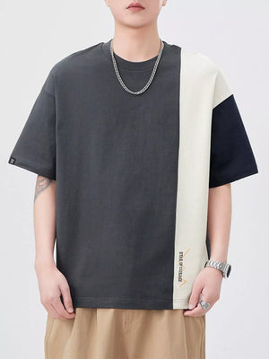 Oversized cotton t-shirt with color block design in dark gray, cream, and navy.