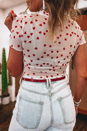 White sheer t-shirt with red hearts, short sleeves, and a cropped fit.