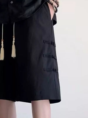 Black chino shorts with drawstring and frog button details.