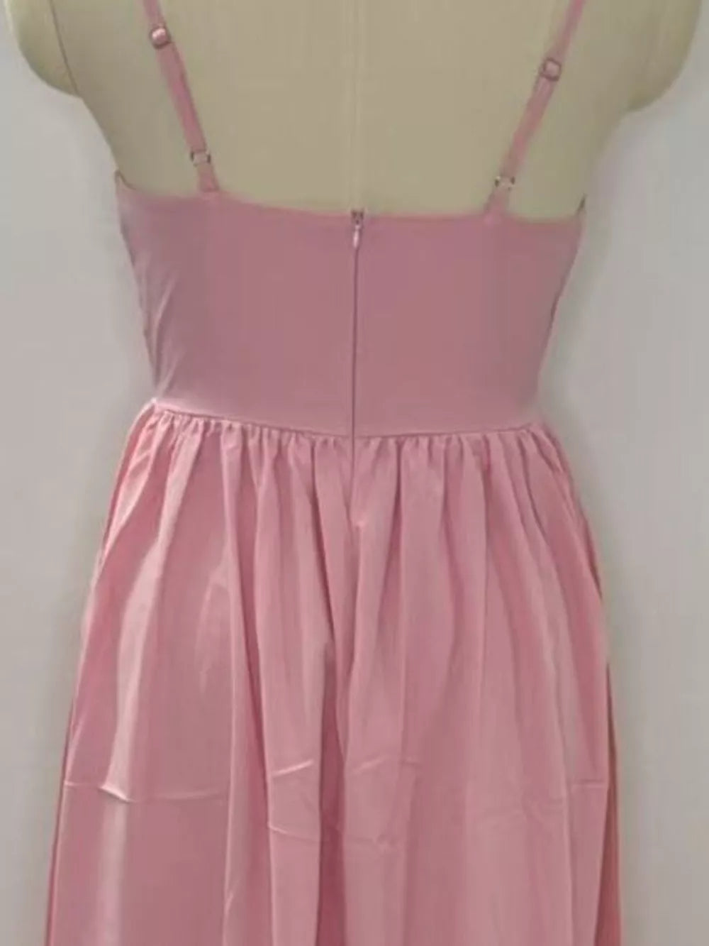 Blush pink midi dress with adjustable straps and a gathered waist
