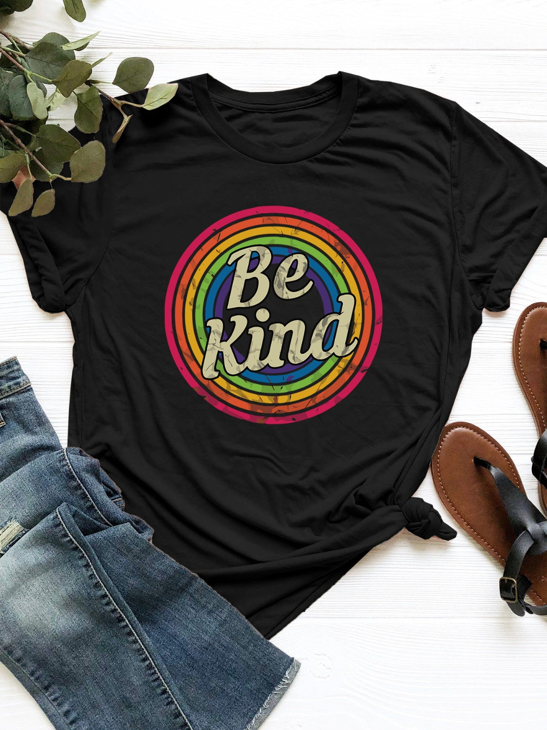 Black t-shirt with retro rainbow graphic and "Be Kind" text.