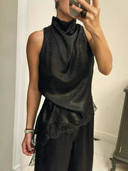 Black asymmetrical cami top with lace trim and mock neck.