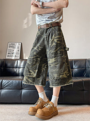 Men's vintage camouflage cargo capris with multiple pockets and frayed hem.