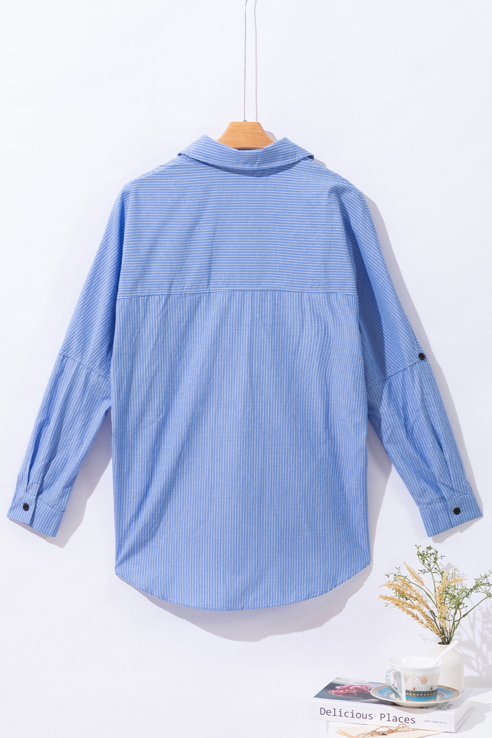 Light blue relaxed fit button-down shirt with vertical pinstripes and roll-tab sleeves.