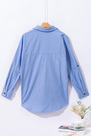 Light blue relaxed fit button-down shirt with vertical pinstripes and roll-tab sleeves.