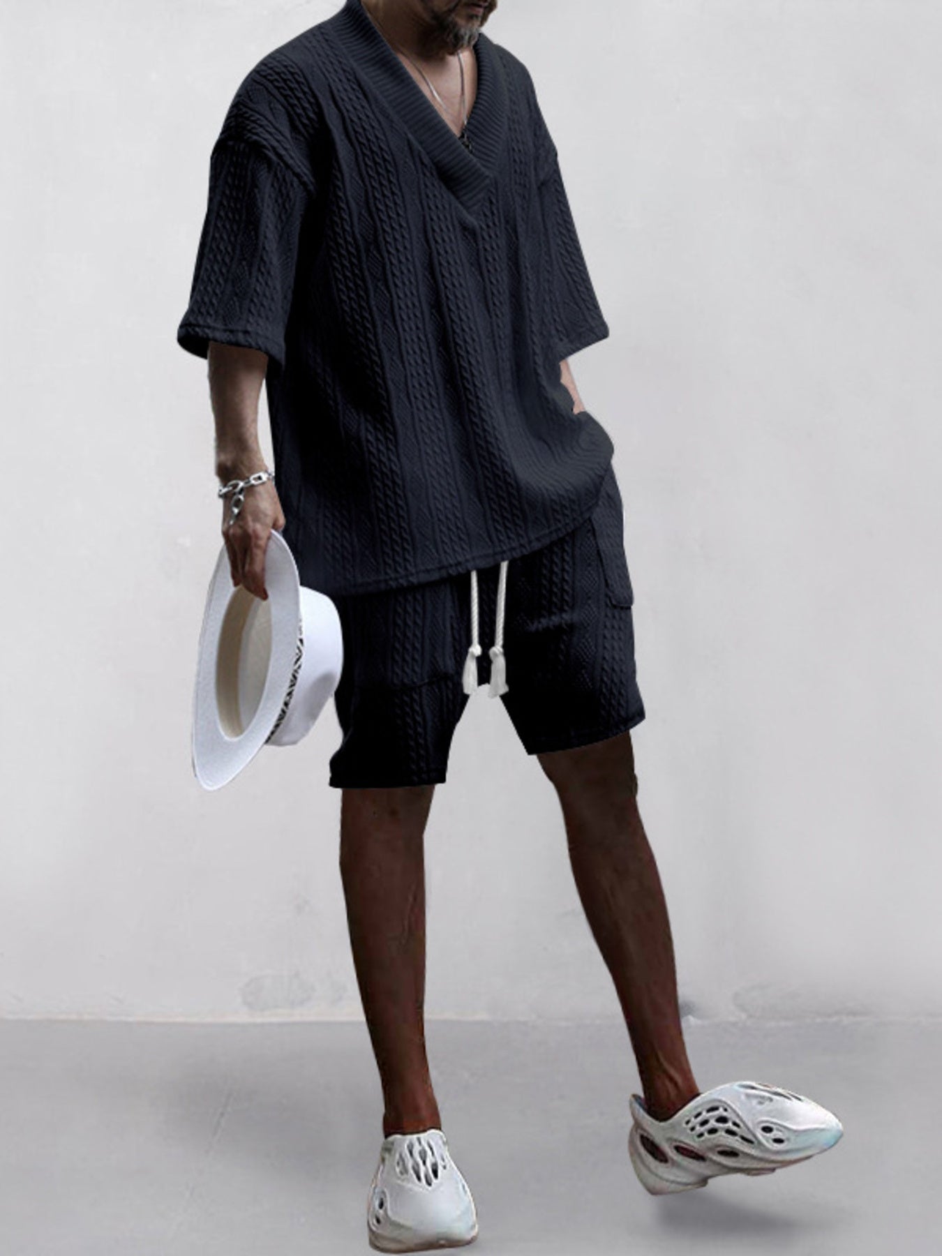 Black cable-knit V-neck two-piece set with shorts and short sleeves.
