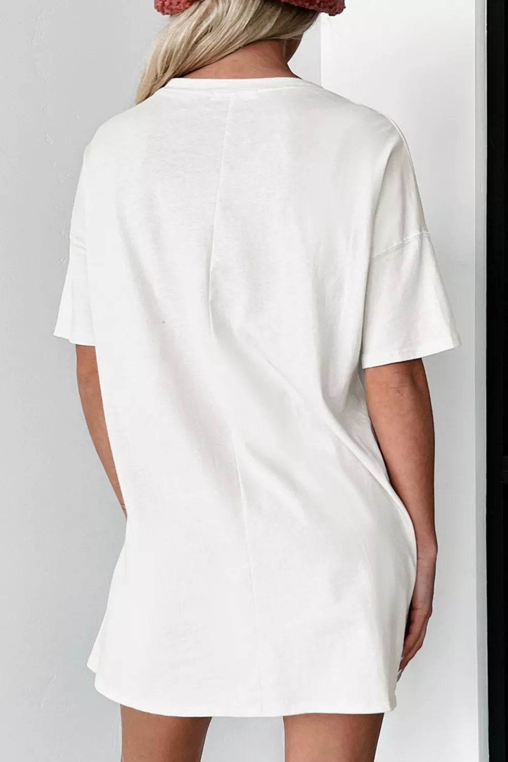 White cotton oversized t-shirt with short sleeves and a crew neck, shown from the back.