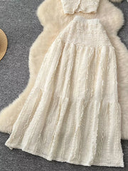 White textured two-piece set with ruffled details and tiered skirt.