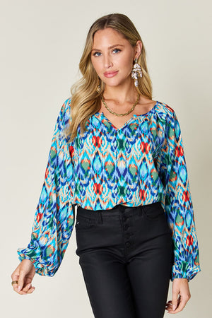 Prismatic ikat blouse in blue with voluminous sleeves and v-neck