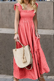 Smocked gingham maxi dress with flutter sleeves and ruffle hem.