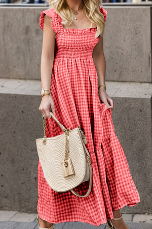 Smocked gingham maxi dress with flutter sleeves and ruffle hem.