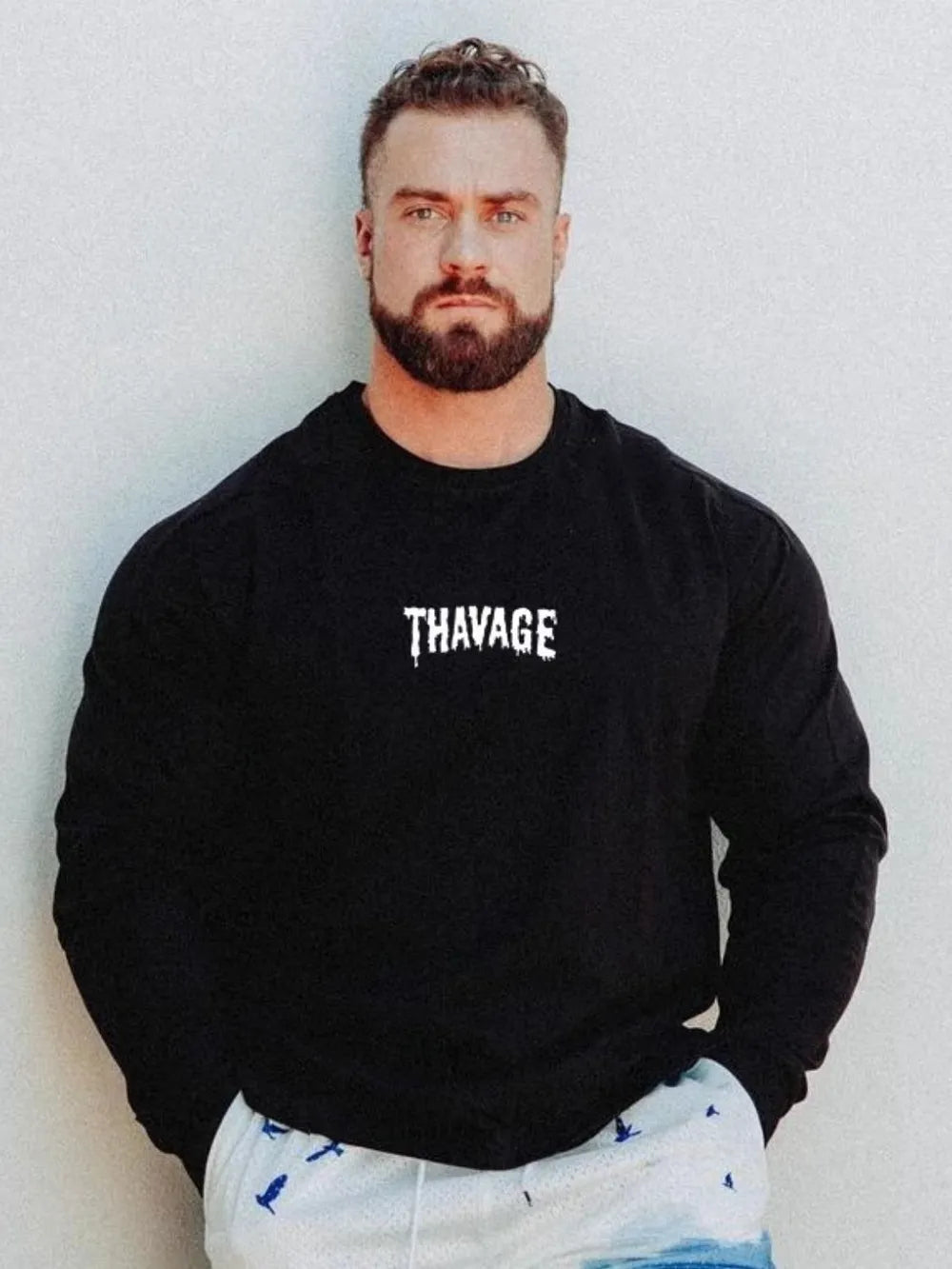 Black long sleeve t-shirt with white dripped logo detail on chest.