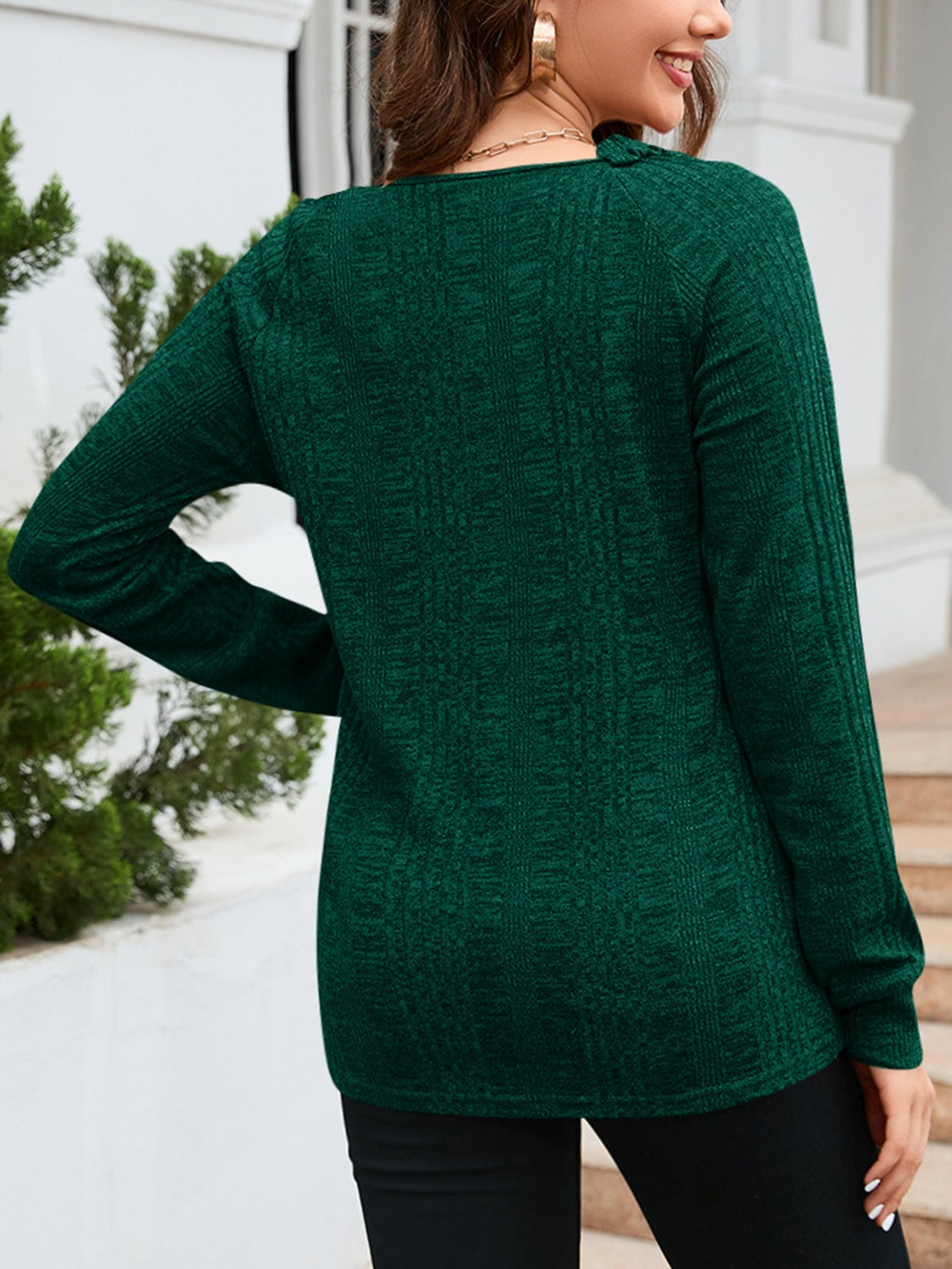 Green textured knit sweater with raglan sleeves and a subtle vertical pattern.