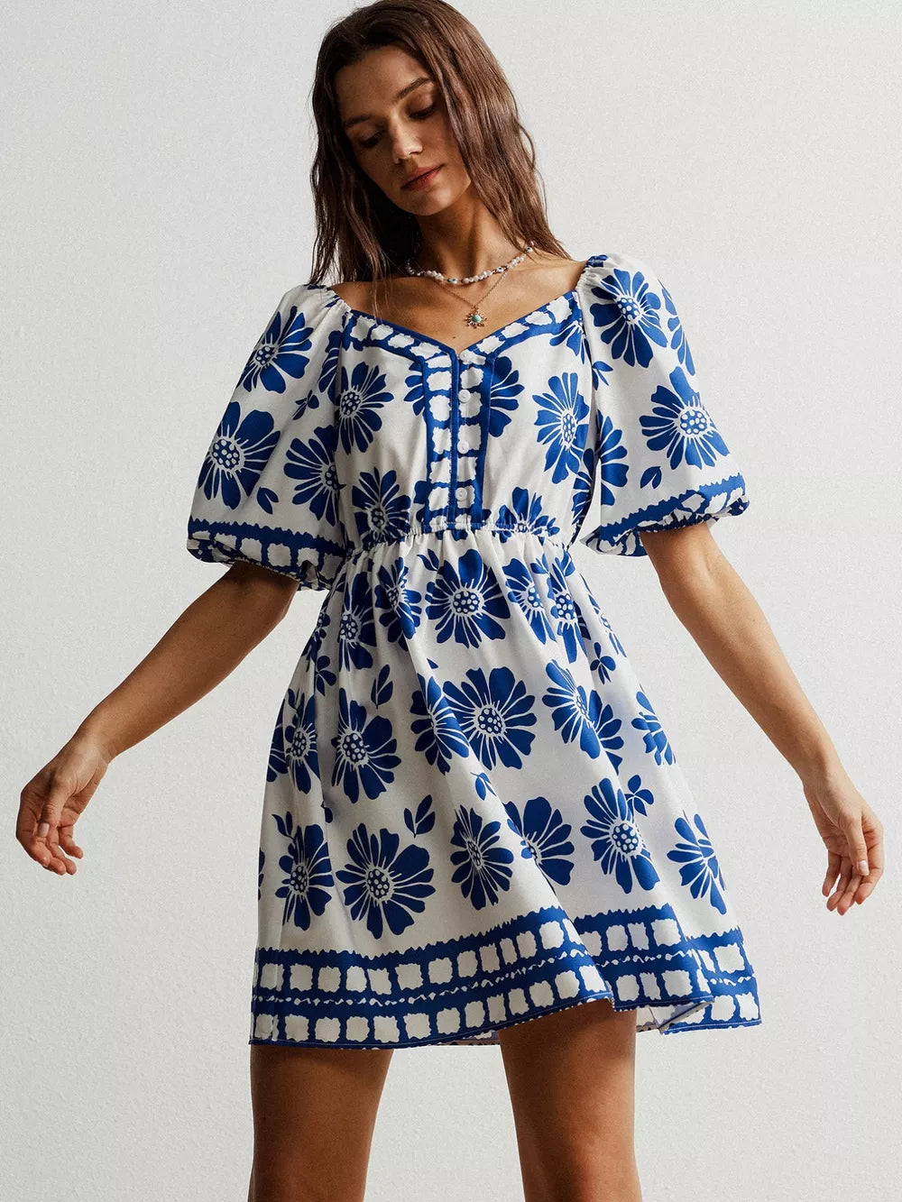 Blue floral puff sleeve mini dress with button front and square neckline.