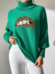 Green turtleneck sweater with sequin lip detail and leopard print accents.