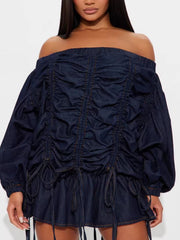 Dark navy denim dress with off-the-shoulder neckline, balloon sleeves, and adjustable ruching detail.