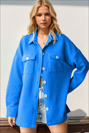 Diamond quilted oversized shirt jacket in blue with button front and chest pockets.