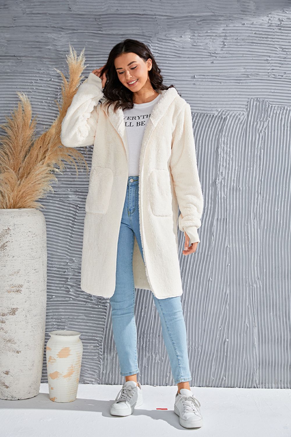 Plush hooded duster in cream with thumbhole cuffs and pockets.
