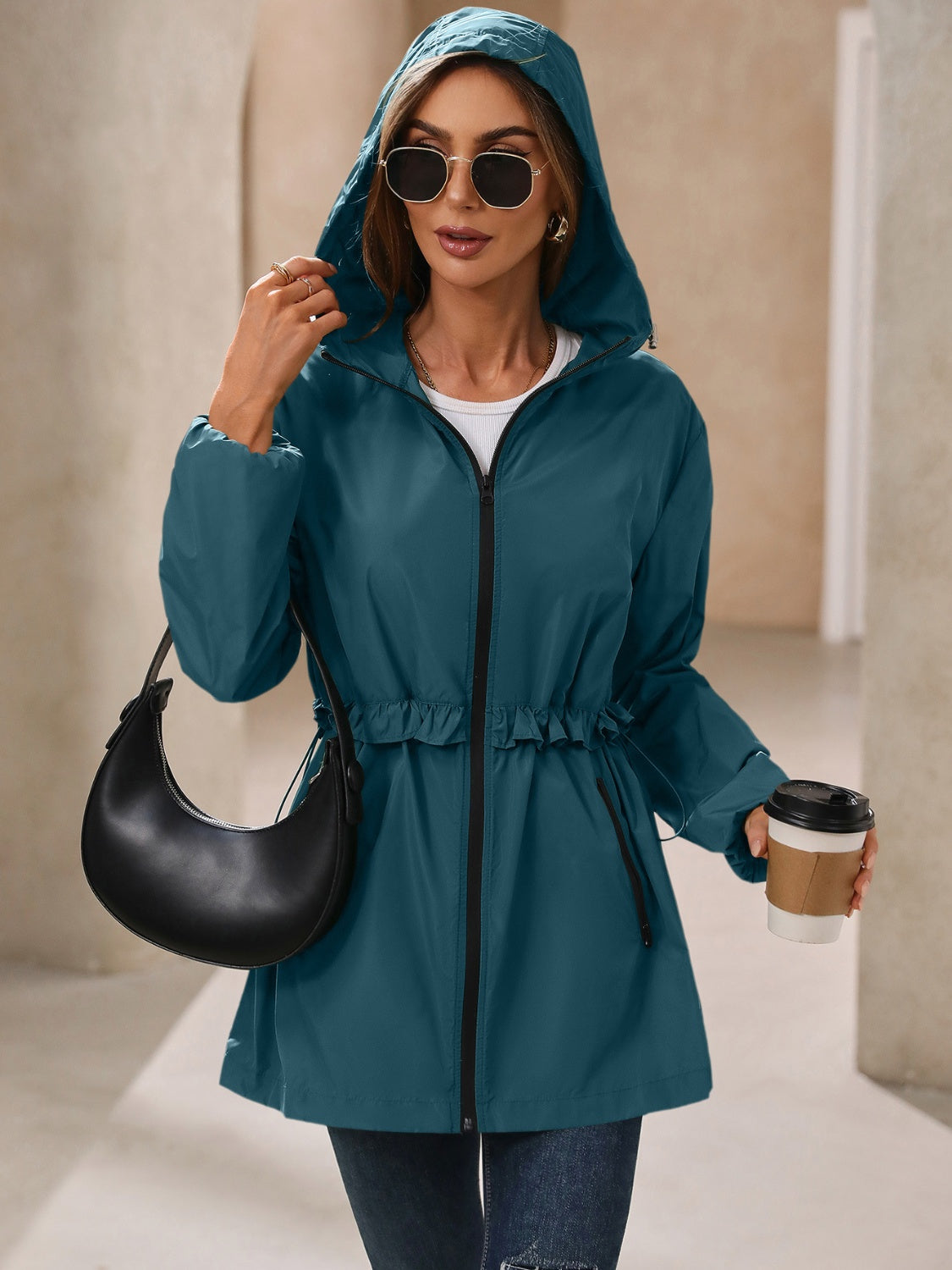 French blue hooded windbreaker jacket with ruffled waistline and full zip.