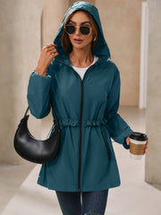 French blue hooded windbreaker jacket with ruffled waistline and full zip.
