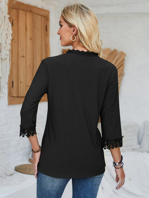 Black eyelet trim v-neck blouse with 3/4 sleeves and lace cuffs.