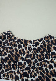 Leopard print waffle knit henley sweater with crew neck.