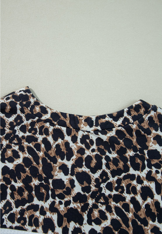 Leopard print waffle knit henley sweater with crew neck.