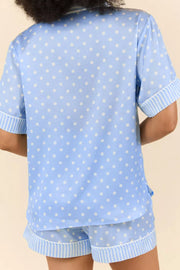 Blue polka dot viscose pajama set with striped trim shorts and short sleeve button-down top.