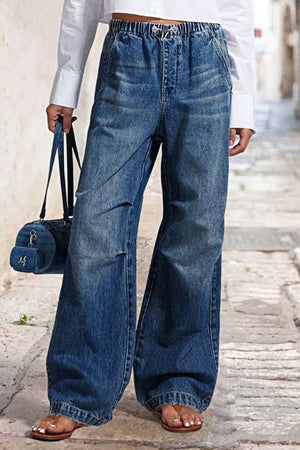 Medium wash denim palazzo jeans with elastic waist and drawstring detail.