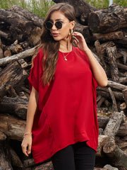 Scarlet red blouse with asymmetrical draped sleeves and a relaxed fit.