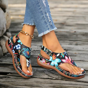 Embroidered floral thong wedge sandals with adjustable ankle strap.
