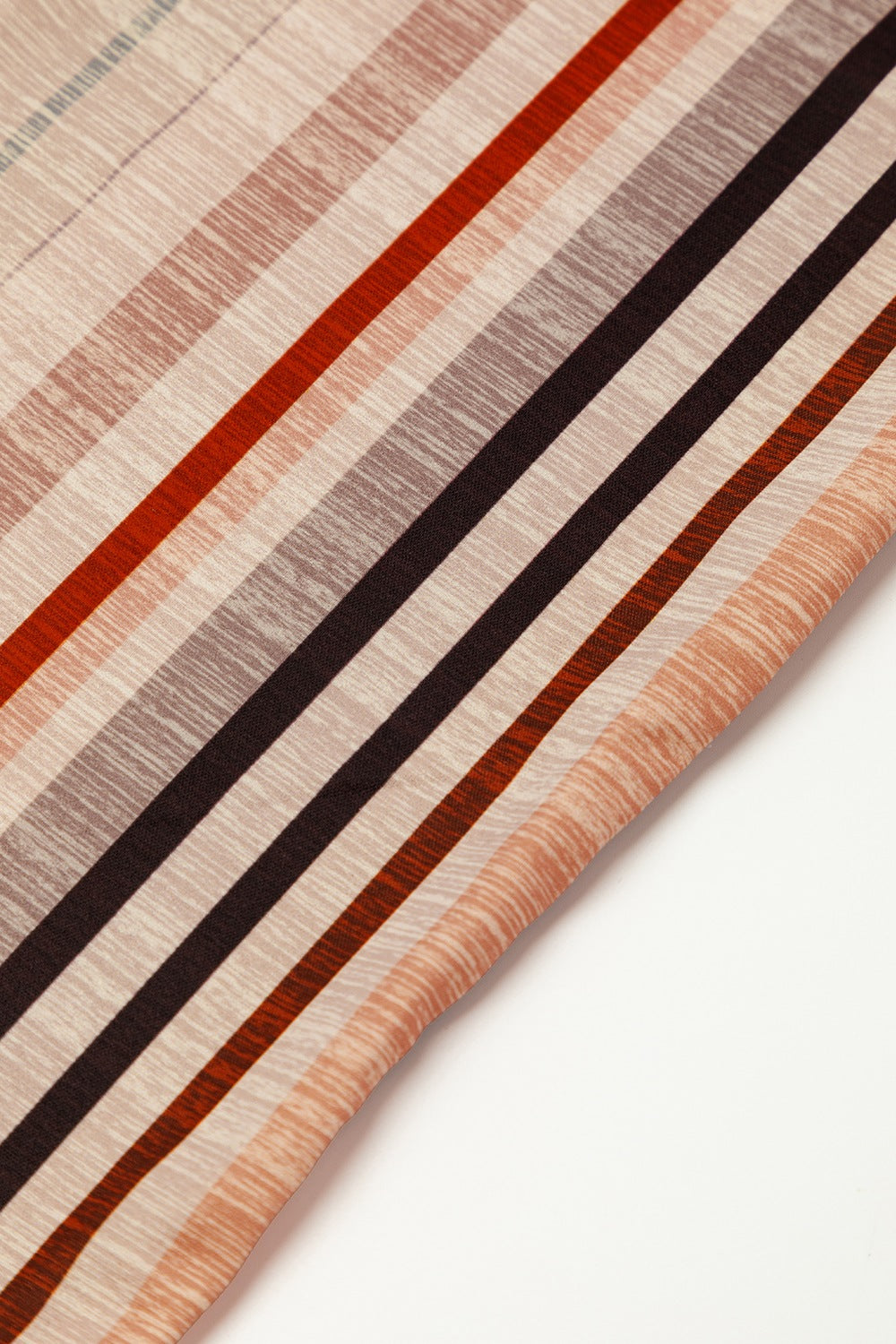 Striped square neck wide-leg romper in tan with rust, brown, and grey stripes.