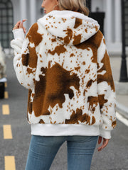 Brown cowhide print sherpa zip-up hoodie with white trim and hood.