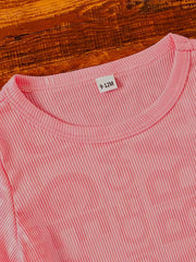Pink ribbed knit baby tee with crew neck and size tag