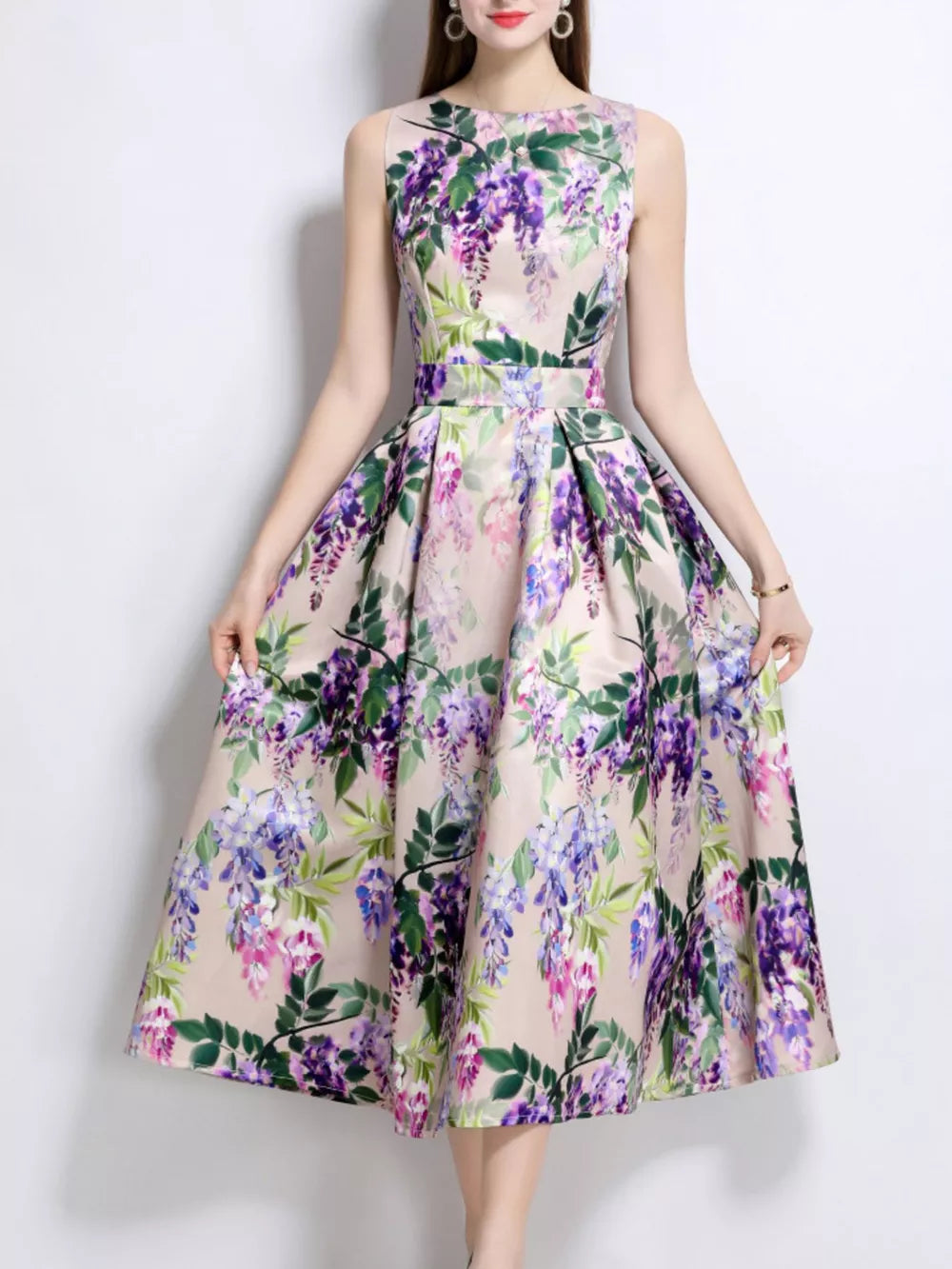 Wisteria floral print midi dress in blush pink with a-line cut and sleeveless design.