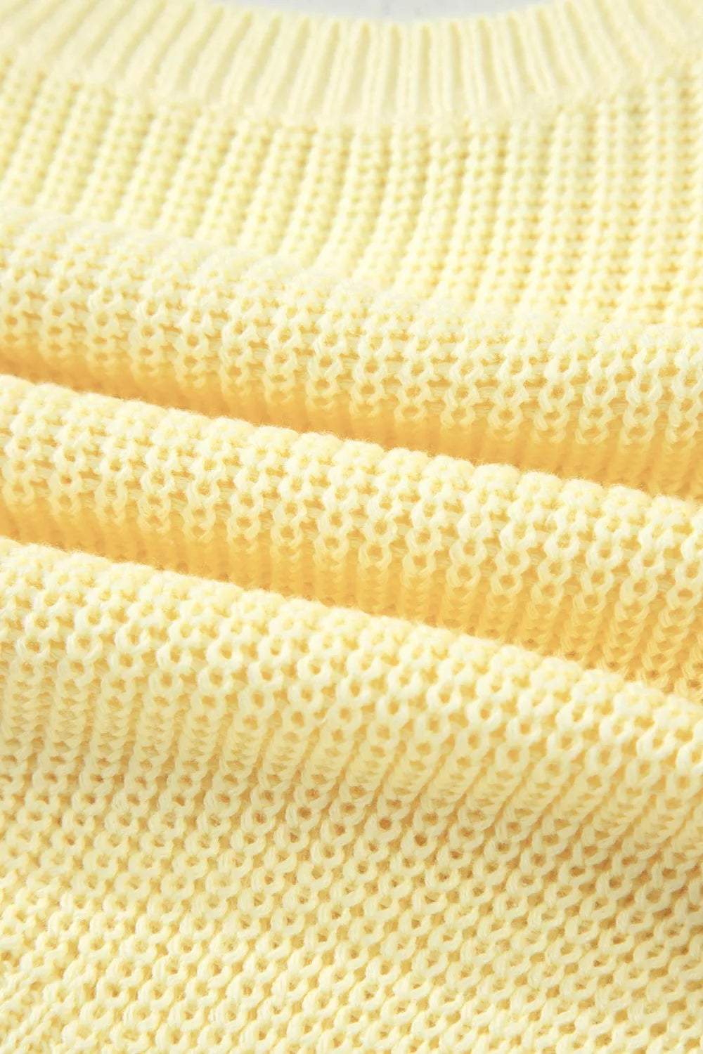 Yellow knit sweater vest with a textured stitch detail.